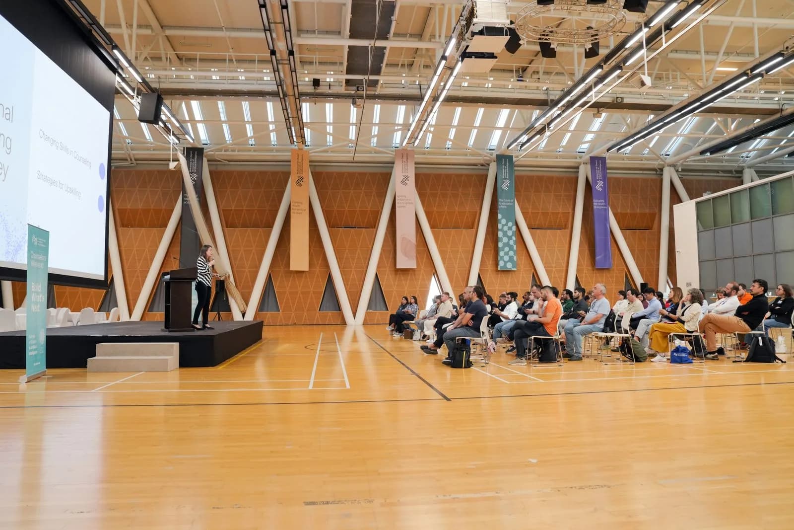 Illustrative conference photograph of a speaker addressing delegates